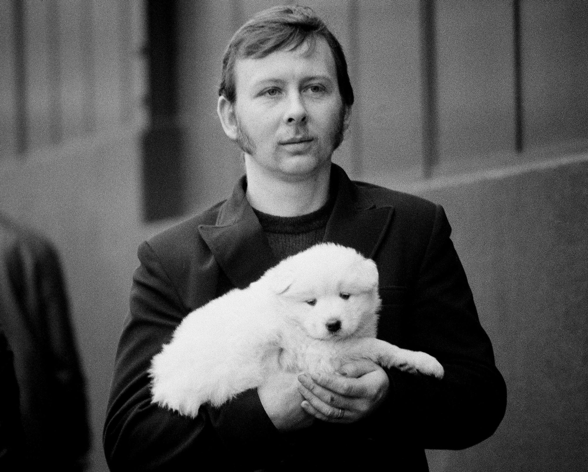 S_B&W_Dog_Show_Man_Carrying_Little_White_Dog_10